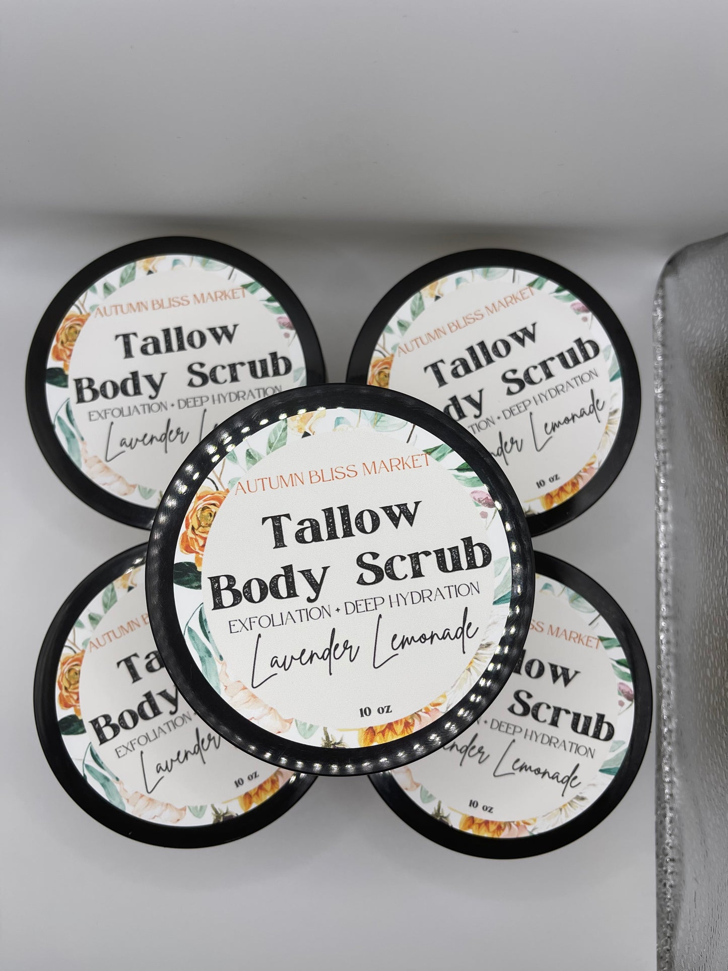 Multiple number of Tallow Body Scrub on a silver surface.
