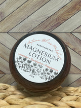 A jar of Magnesium lotion placed on a woven mat with a wooden background.