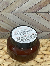 A jar of Magnesium lotion placed on a woven mat with a wooden background.
