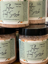 Jars of Tallow Foot Scrub with labels indicating the product is a 11 oz (320 ml) organic foot scrub that contains pink Himalayan sea salt, peppermint, tea tree and tallow.