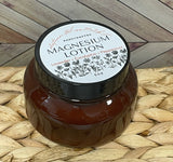 A jar of Magnesium lotion placed on a woven mat with a wooden background.