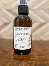Magnesium Oil Spray showing the ingredients and directions, placed on a wooden surface.